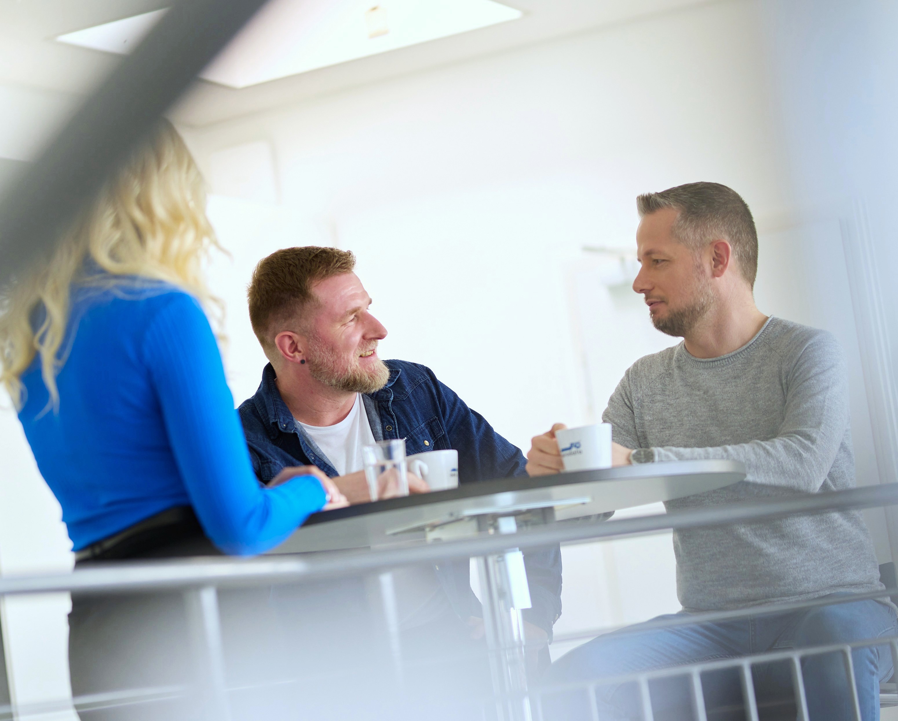 Three employees having a chat